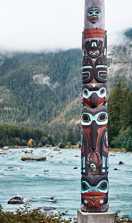 Totem pole on the bank of an Alaska stream