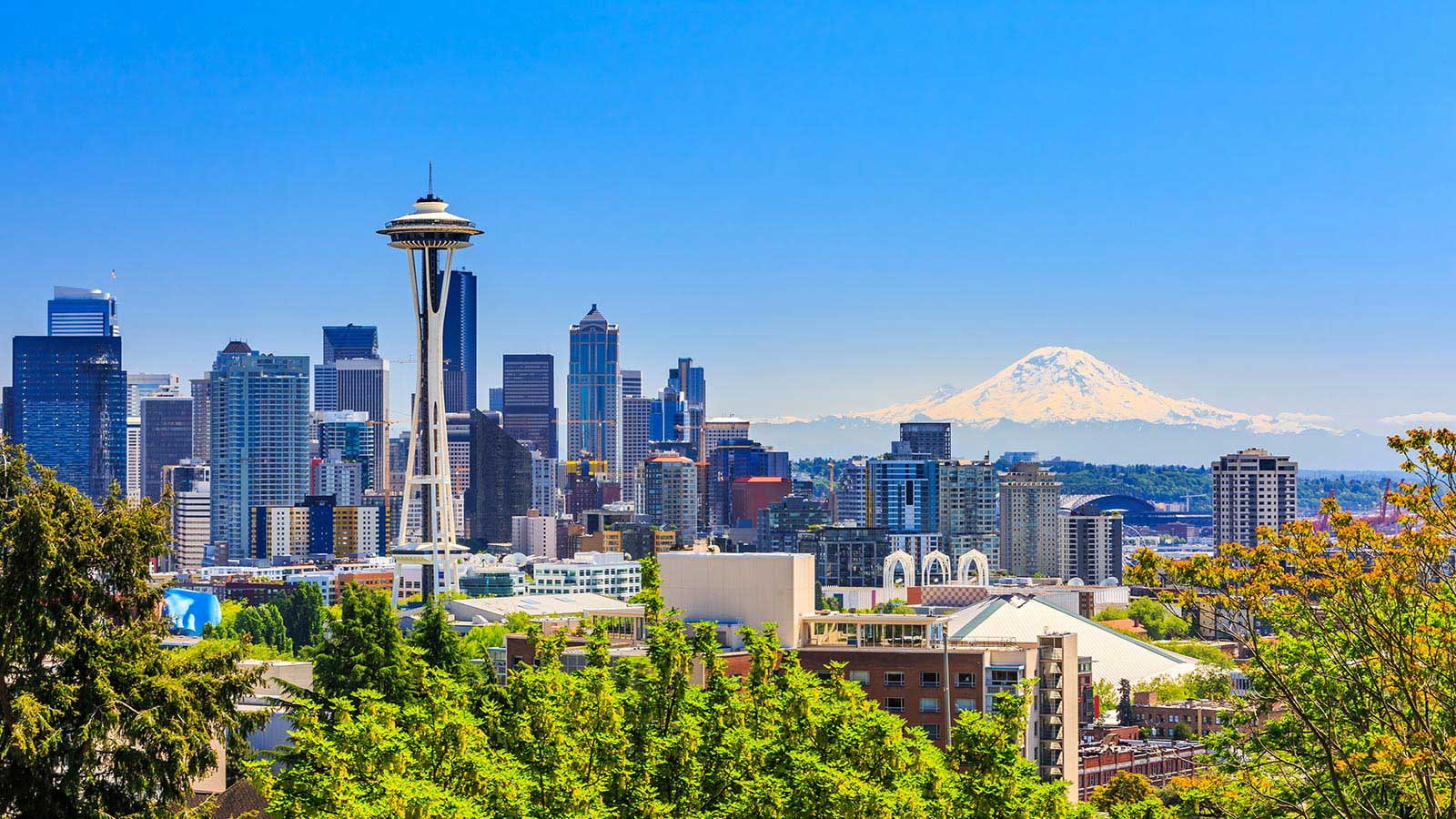 Seattle city skyline with snow-capped mountain in distance